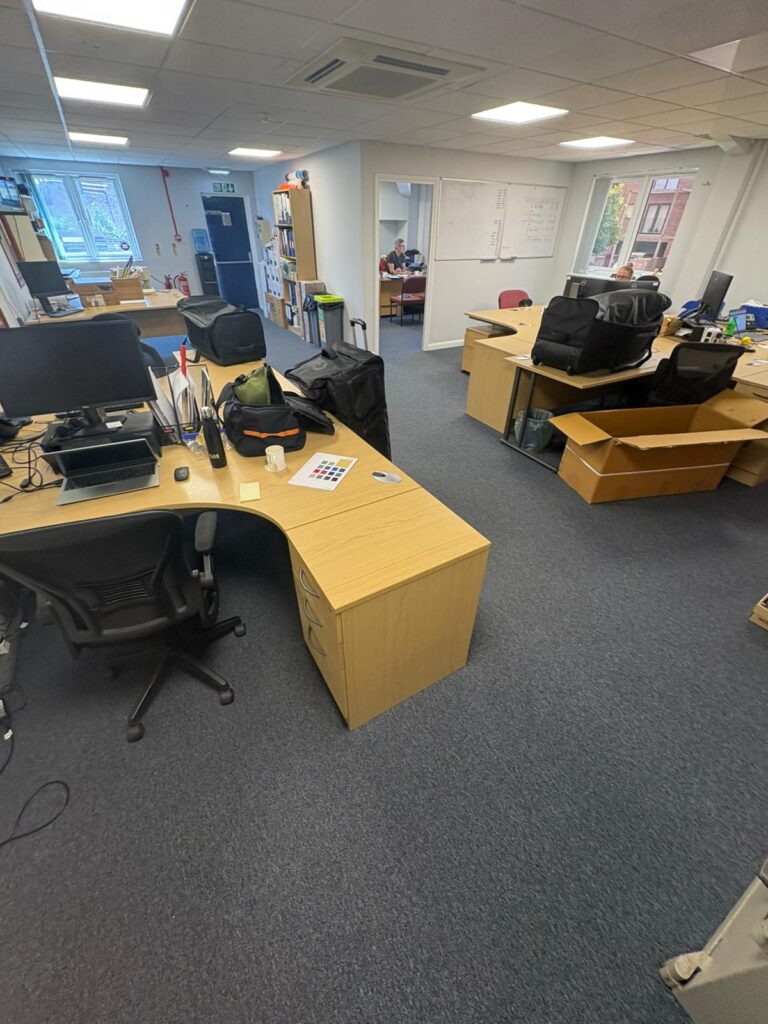 Burmatex Coal Grey carpet tiles fitted across an open-plan office at the Gunn & Moore factory in Nottingham