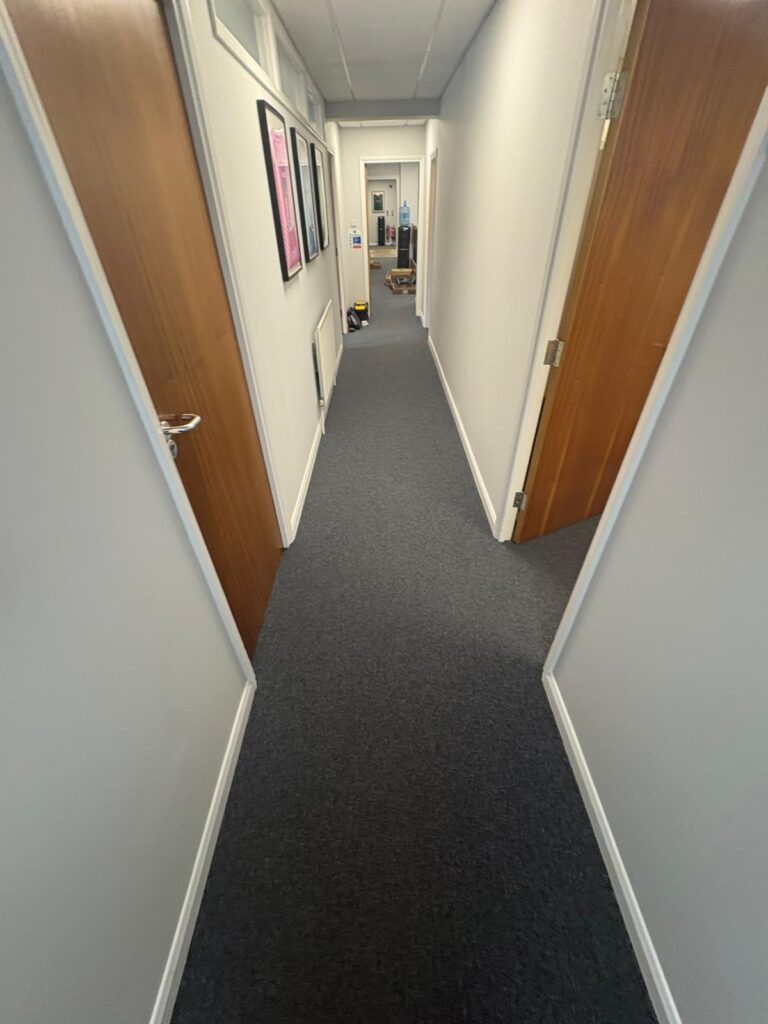 Coal Grey carpet tiles laid along an office corridor at Gunn & Moore, Nottingham