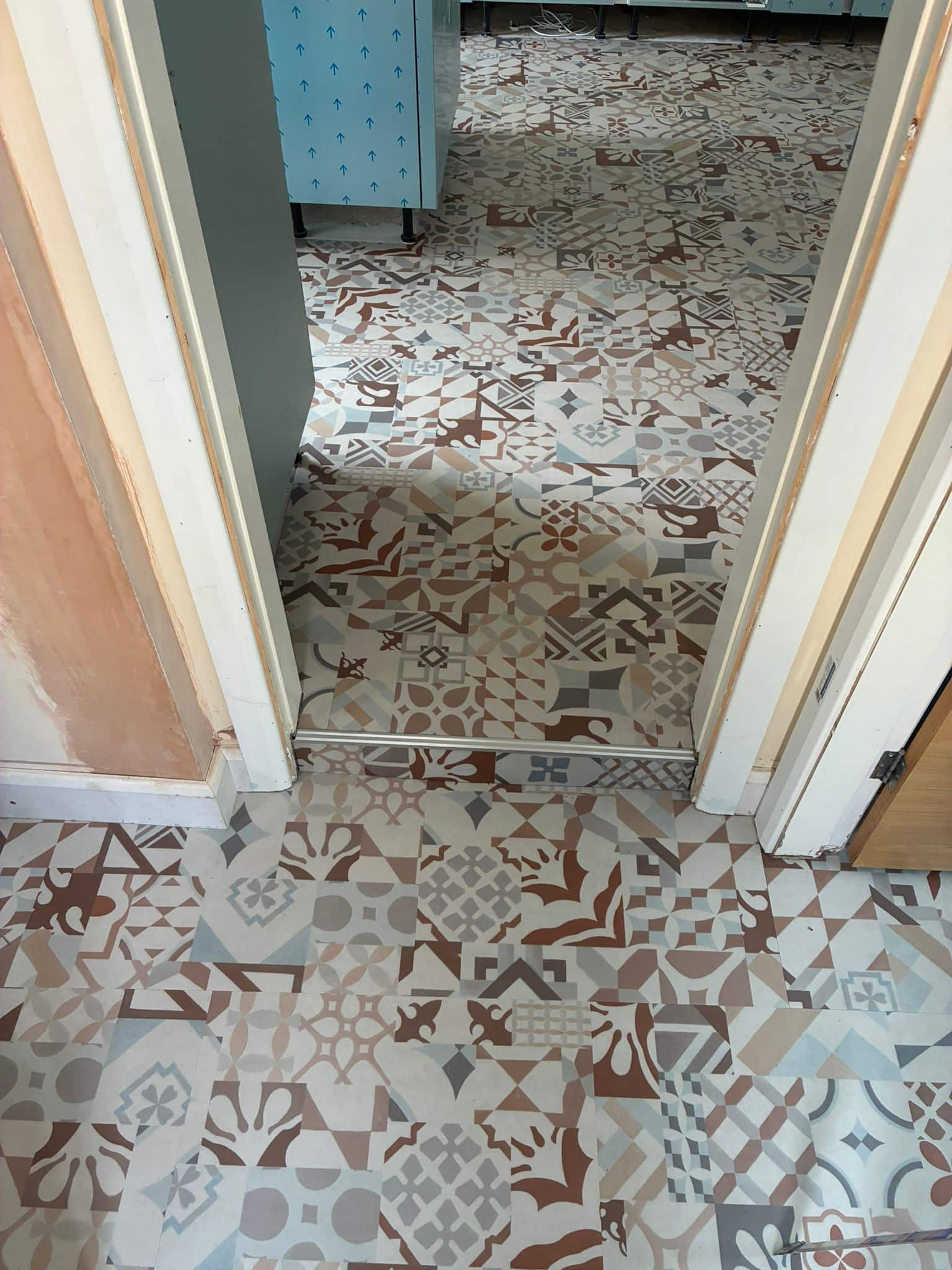 Close-up of the Karndean Marrakesh patchwork pattern in terracotta, blue and grey tones