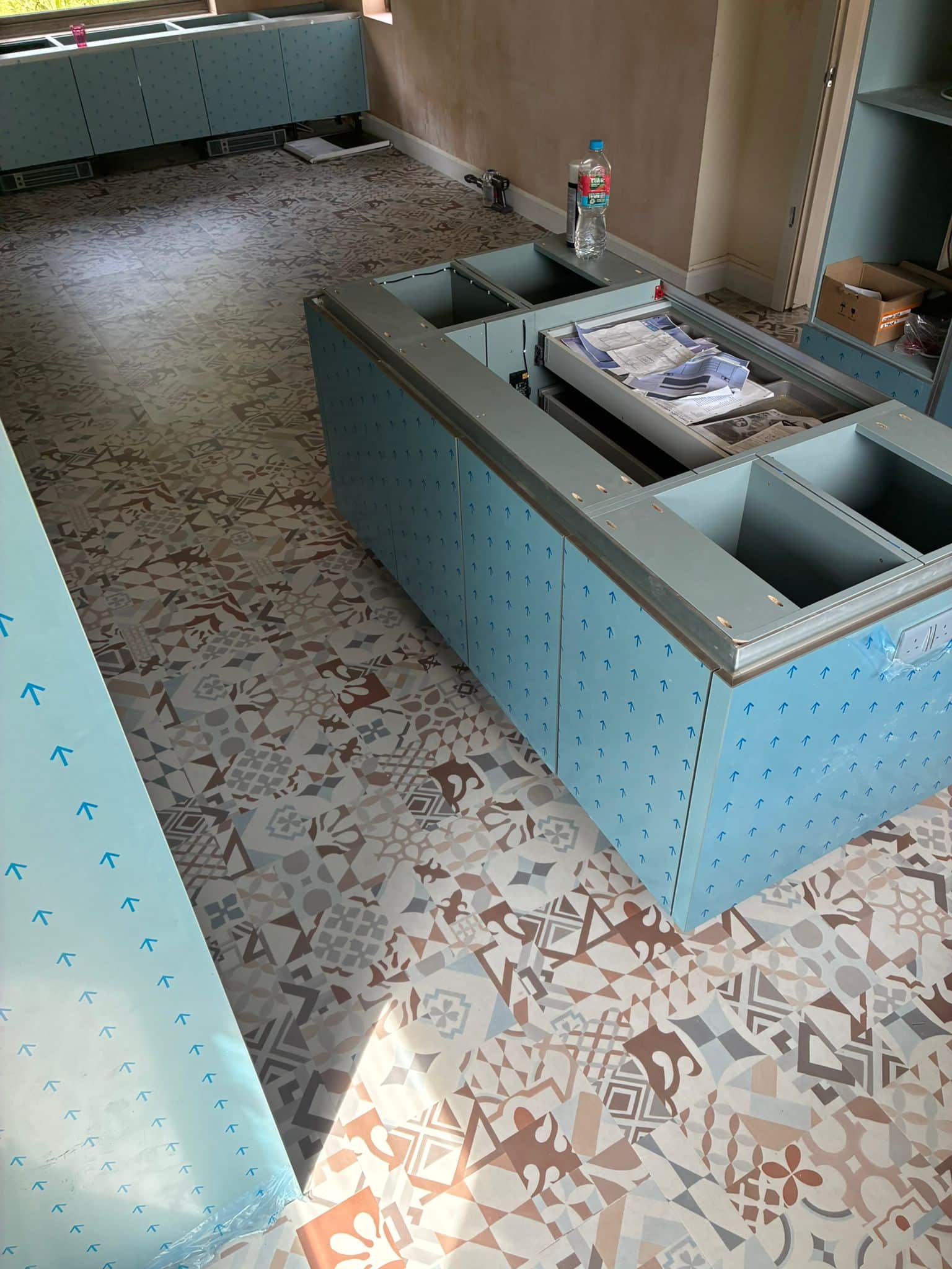 Karndean Marrakesh LVT installation in progress in a family kitchen with units protected
